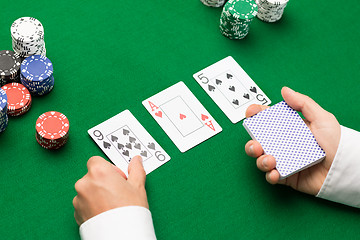 Image showing holdem dealer with playing cards and casino chips