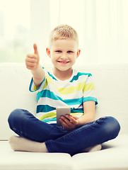 Image showing smiling boy with smartphone showing thumbs up