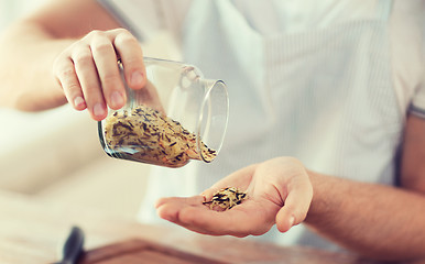 Image showing male emptying jar with white and wild black rice