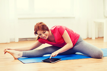 Image showing smiling teenage girl streching on floor at home