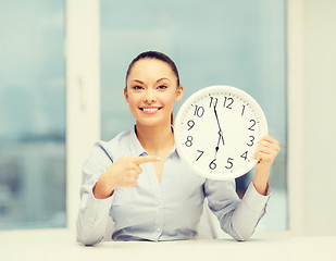 Image showing attractive businesswoman with white clock