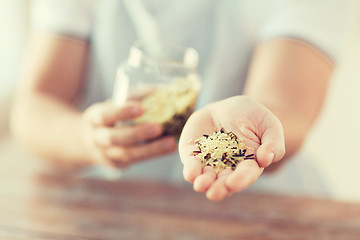 Image showing male with white and wild black rice on palm