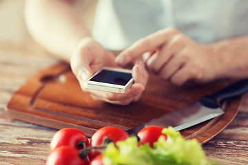 Image showing closeup of man pointing finger to smartphone