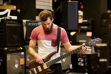 Image showing musician or customer with guitar at music store