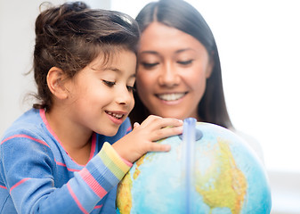 Image showing mother and daughter with globe