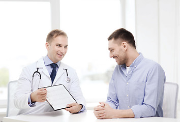 Image showing doctor with clipboard and patient in hospital