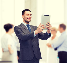 Image showing smiling buisnessman with tablet pc computer