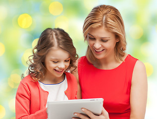 Image showing mother and daughter with tablet pc over green