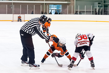 Image showing Puck playing between players of ice-hockey teams