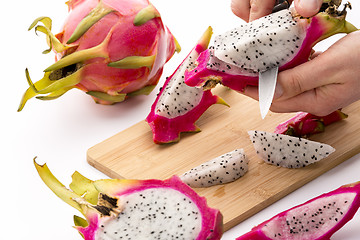 Image showing Cutting Pitaya Fruit Flesh Off Its Purple Skin