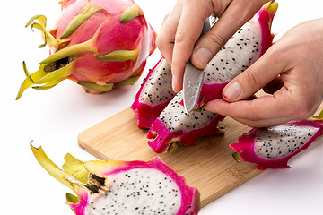 Image showing Knife Positioned To Peel A Pitaya Fruit Wedge