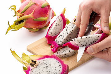 Image showing Chef’s Hands Detaching Pulp From A Pitaya Wedge