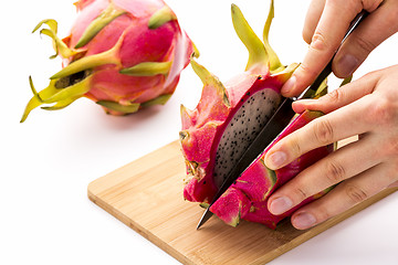 Image showing Opening A Ripe Dragonfruit With A Longitudinal Cut