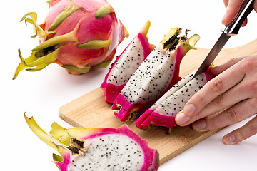 Image showing Third And Last Cut Through A Halved Dragonfruit