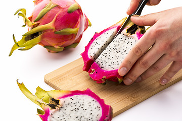 Image showing Cutting Off A First Fruit Chip From A Pitaya Half