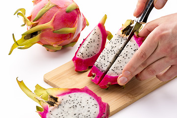 Image showing Knife Cutting Half A Pitaya Into Fruit Chips
