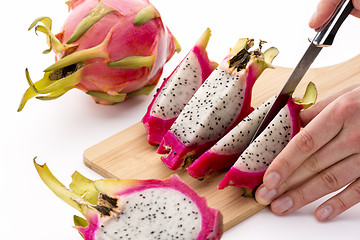 Image showing Cutting A Halved Pitaya Into Four Fruit Wedges