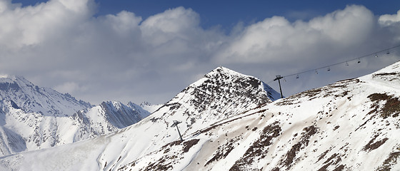 Image showing Off-piste slope and chair-lift in little snow year. Panoramic vi