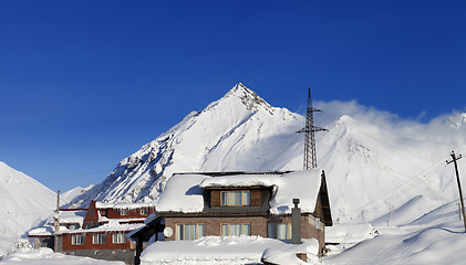 Image showing Hotels in winter snowy mountains at sun day