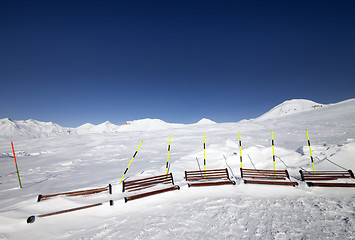 Image showing Ski slope and wooden benches in snow