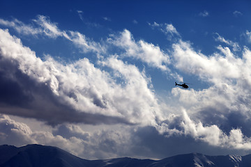 Image showing Helicopter in cloudy sky