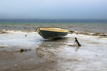 Image showing Fishing boat on the shore of the Baltic Sea. Winter landscape