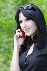 Image showing Smiling girl talking on the phone