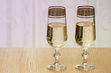 Image showing Two champagne flute filled with champagne.