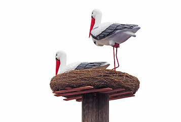 Image showing Sculpture of storks in the nest on a white background.