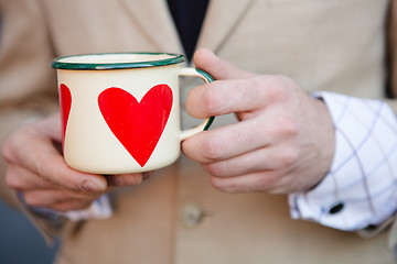 Image showing man holding hot cup of coffee