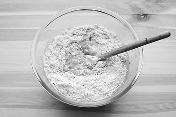 Image showing Flour being stirred into batter for banana bread