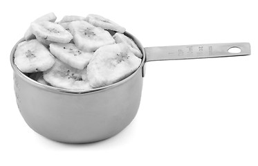 Image showing Dried banana chips in a cup measure