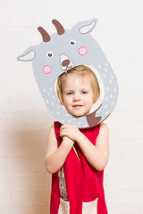 Image showing Little girls holding goat mask on white background