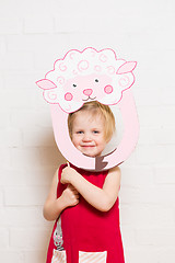 Image showing Little girls holding sheep mask on white background