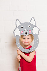 Image showing Little girls holding wolf mask on white background