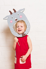 Image showing Little girls holding goat mask on white background