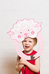 Image showing Little girls holding sheep mask on white background