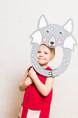 Image showing Little girls holding wolf mask on white background