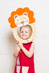 Image showing Little girls holding lion mask on white background