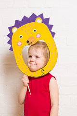 Image showing Little girls holding hedgehog mask on white background