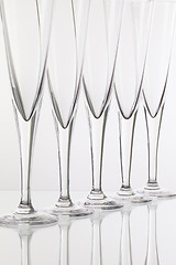 Image showing Empty champagne glasses on the glass desk