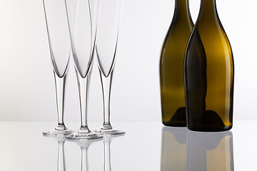 Image showing Empty champagne glasses on the glass desk