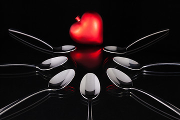 Image showing Teaspoons and love symbol on the black glass desk