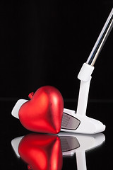 Image showing Golf putter and love symbol on the black glass desk