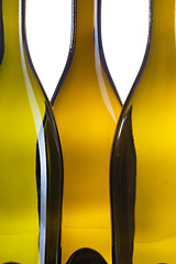 Image showing Detail of three empty wine bottles