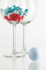 Image showing Two glasses of wine and golf equipments