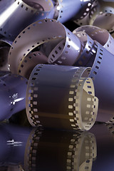 Image showing Close-up of a roll 35 mm photographic films on a glass desk