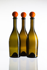 Image showing Empty three  wine bottles and golf balls