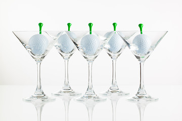 Image showing Five glasses of champagne and golf equipments 