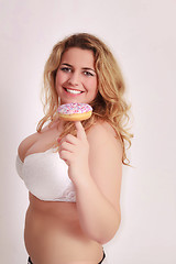 Image showing Woman with big tits has a colorful muffin on the finger